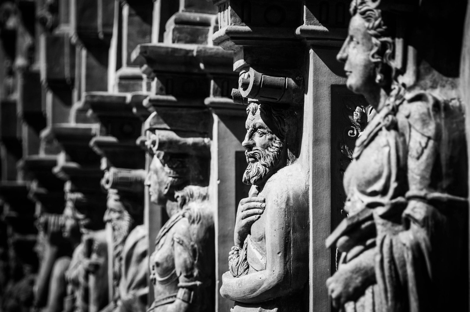 Black and white photo of historic stone sculptures showcasing intricate craftsmanship.